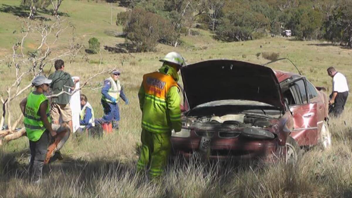 DRAMATIC SCENES: Rescue workers at the Turondale crash site where a 12-year-old boy managed to crawl from the wreckage and raise the alarm. Photo: ANDREW MICALLEF, WIDE AREA COMMUNICATIONS 032513crash2